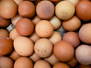 pile of freshly laid brown eggs, showcasing their natural texture and warm tones. Perfect for food photography