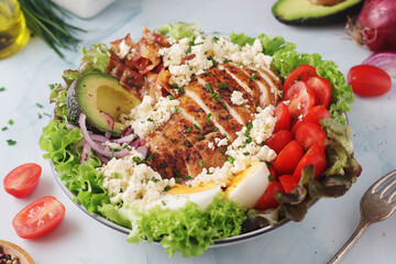 A bowl with cobb salad, traditional American dish