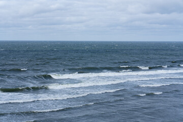 Fototapeta premium Baltic Sea: panorama of waves captured by a telephoto lens on a cloudy day.