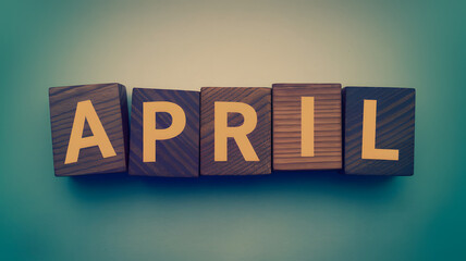 Obraz premium April Wood Block Words on Gradient Background
