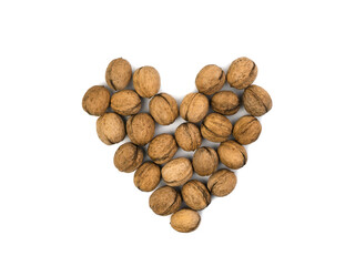 Walnuts in shell in the shape of heart isolated on white background. Creative composition for Valentine's Day. Healthy Food Concept. Top view.