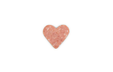 Creative composition for Valentine's Day with slice of sausage cut in heart shape and isolated on white background. Top view.
