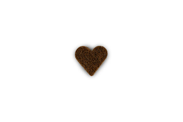 Rye black bread cut into heart shape and isolated on white background. Creative composition for Valentine's Day. Top view.