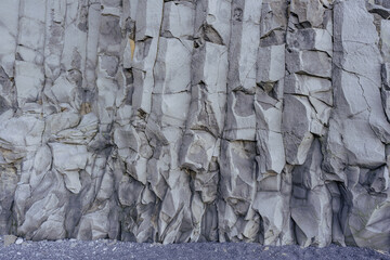 An abstract natural texture of an Icelandic slope structure, revealing stunning patterns, minerals, and the interplay of volcanic rock, sand, and erosion.