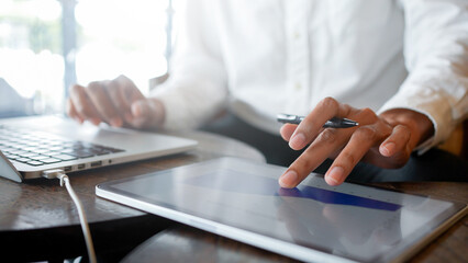 close up executive hand use pencil to check and write about summary report annual and quater with virtual interface of chart and graph and statistic on dashboard for business improvement concept