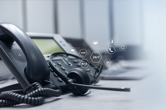 close up telephone voip machine with virtual icon of service provider of communication technology in the office desk operation station room for business and contact us concept