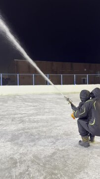 Water flows with high pressure from the hose during ice rink resurfacing high quality 4k footage