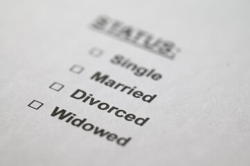 White sheet with the text Status and focus on the word Divorced. Condition of divorced people.