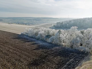 Winter landscape in Germany with frozen frost on trees and fields, drone shot © A.Freund