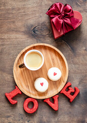 Coffee and macaroons on a wooden tray. Festive table setting. Valentine's Day concept.