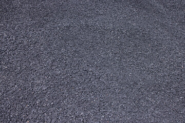 Black fine gravel fills the background. Texture