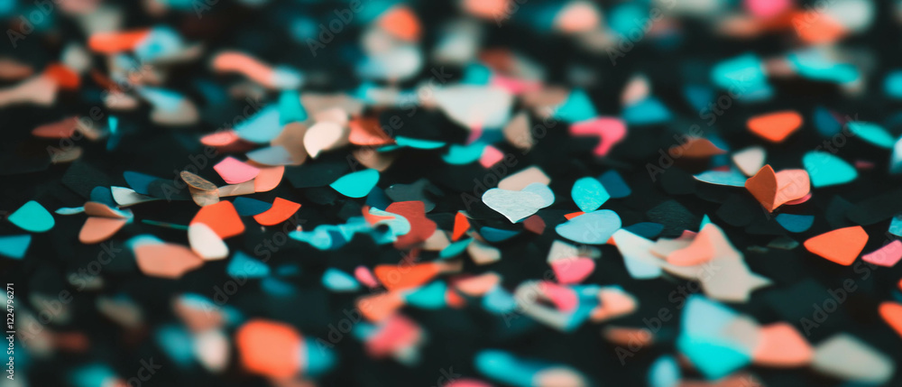 Poster Macro view of colorful confetti on a black background with intricate details