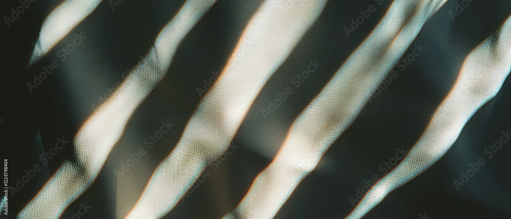 Poster soft light creates wavy curtain shadows against a dark backdrop enhancing atmosphere
