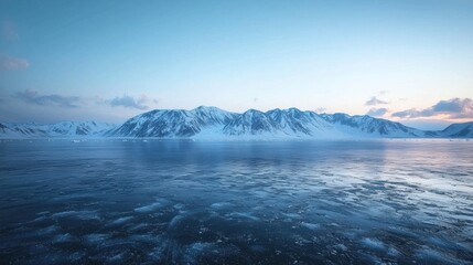 Fototapeta premium Serene Winter Wonderland Landscape with Majestic Mountain Range Under Soft Blue Sky