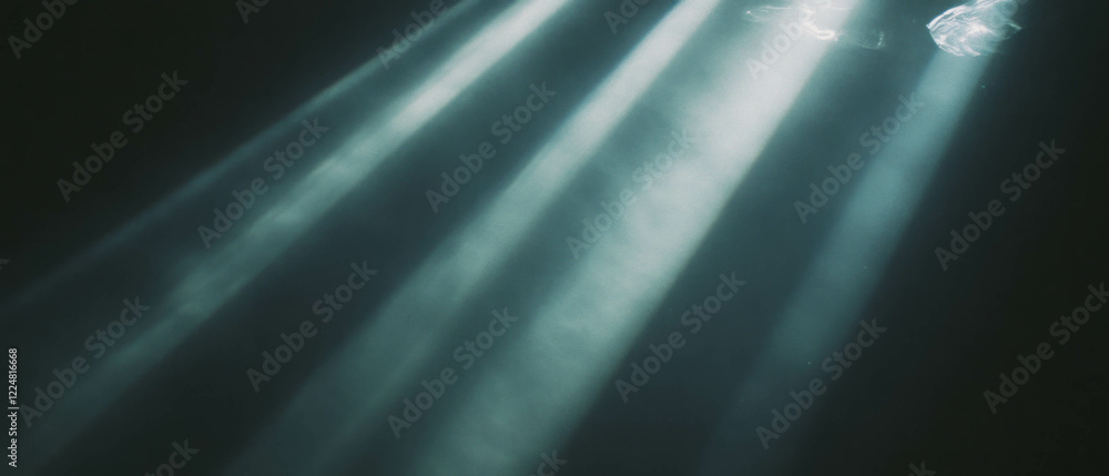 Poster light with defined edges creates a striking contrast against a dark background, adding drama
