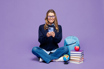 Full body young girl student wears blue casual clothes glasses sit near backpack bag stack of books...