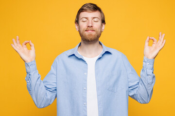 Young spiritual man wear blue shirt white t-shirt casual clothes hold spreading hands in yoga om...