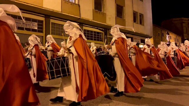 Soria, Spain - 06 April, 2022: Nazarenes playing drums during holy week procession