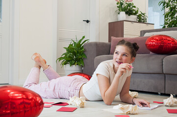 A girl writes a letter for Valentine's day

