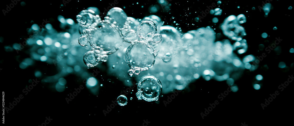 Poster dynamic display of water bubbles against a striking black background with vivid contrast