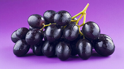 Fototapeta premium Fresh purple grapes with water droplets on vibrant purple background