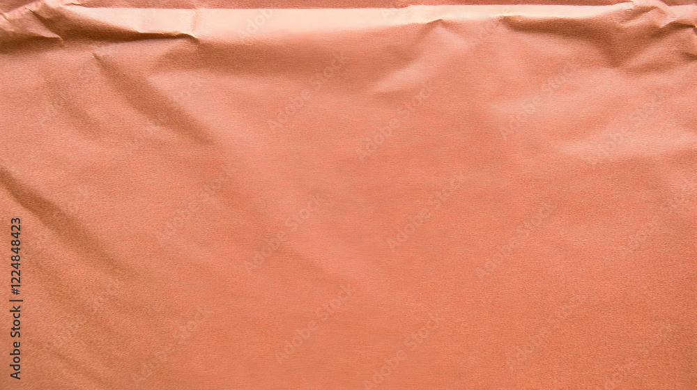 Poster wrinkled peach-colored paper creates a textured background for design projects and creative applicat