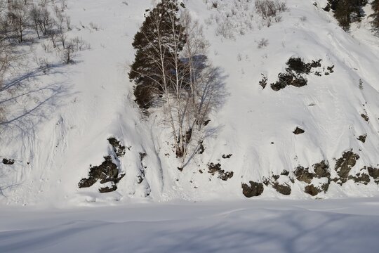 Frozen frozen Malaya Ulba river in the mountains of Eastern Kazakhstan in winter