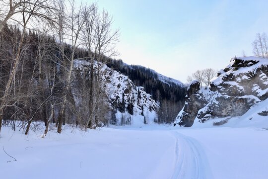 Frozen frozen Malaya Ulba river in the mountains of Eastern Kazakhstan in winter