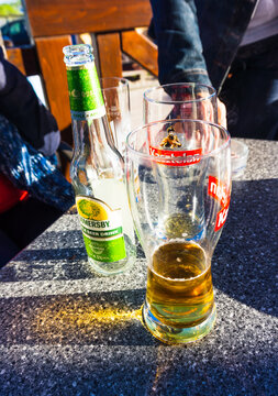Vertical view of Somersby cider and Polish beer on a table under the sunlight