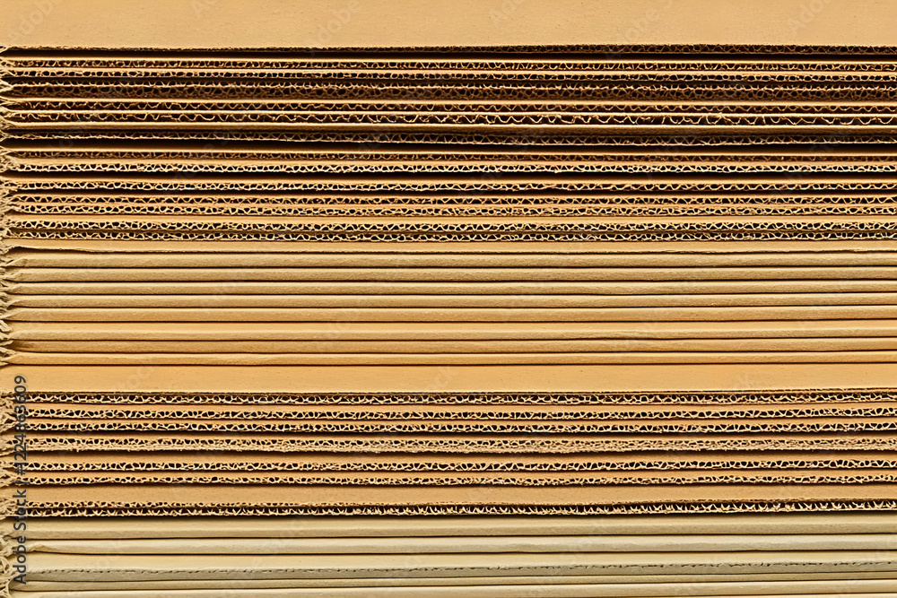 Poster close-up of stacked cardboard sheets showing corrugated layers and texture detail