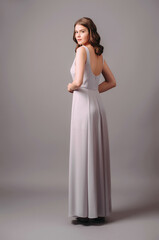 Maxi evening dress with front slit in lilac. Sleeveless purple female evening gown. Young adult...