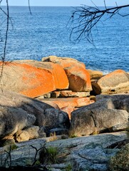 Bicheno Foreshore with orange colour rocks, Tasmania, Australia.