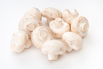 Heap of fresh whole champignons close up on a white background