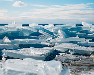 Large chunks of ice on the shore of a frozen lake