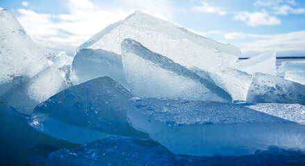 Large chunks of ice on the shore of a frozen lake