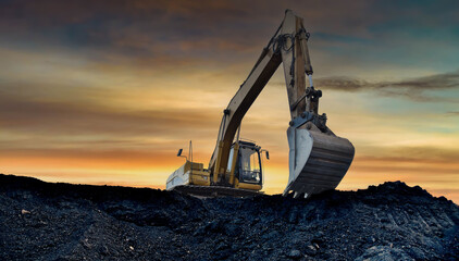 Excavator working on earthmoving at open pit mining. Yellow Backhoe digs sand and gravel in quarry....