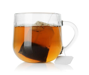 Tea bag in glass cup with hot drink isolated on white