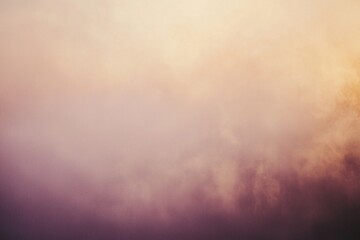 Obraz premium Soft pastel clouds blending at sunset with warm hues creating a serene atmosphere