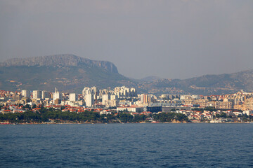 Contemporary buildings, gardens and beaches at the waterfront in Split, Croatia. View of Split from the boat.