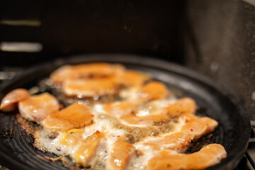 Chicken sizzling in a pan ready to be devoured