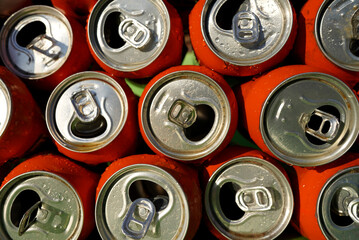 Opened Coke Cans background, texture. Open drink soda cans close up, top view. Open coke can,...