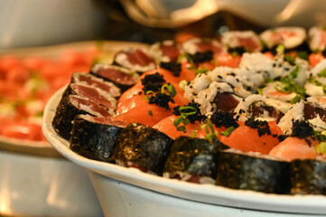 japanese food sushi, sushi on a plate, sushi with salmon and caviar, salmon and caviar, sushi with salmon,  table setting, haute cuisine, japanese food, raw salmon, buffet, restaurant, raw fish
