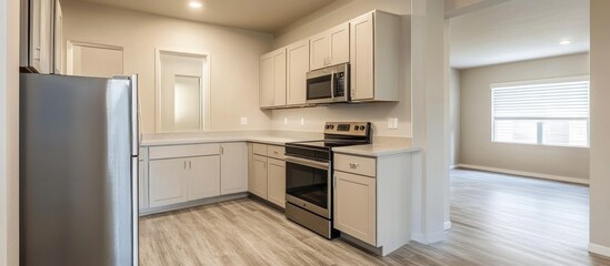 Bright spacious kitchen featuring modern appliances and neutral tones creates a clean and inviting atmosphere