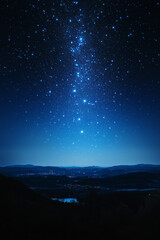 Fototapeta premium Illuminating a tranquil mountain valley, a starry night sky reveals scattered lights below, creating a serene and scenic atmosphere vertical mobile wallpapper