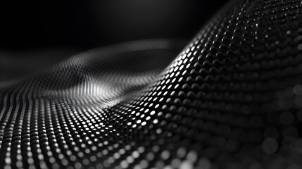 Abstract close-up of a textured surface with a wave-like pattern in black and white tones.