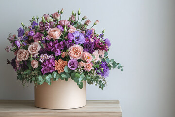 Bouquet of floristry flowers in round box on minimalist background