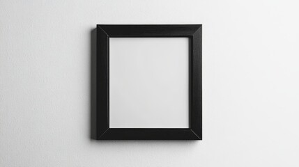 Empty black picture frame on white wall for creative display