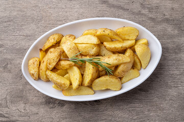 Rustic baked potatoes in a plate over wooden table