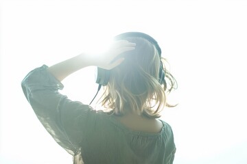 Woman with headphones listening music on mp3 player. Music teenager girl dancing against white background.