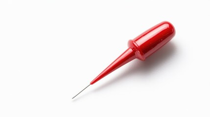 Fototapeta premium Red plastic pushpin lying diagonally on a clean white surface in a studio setting.
